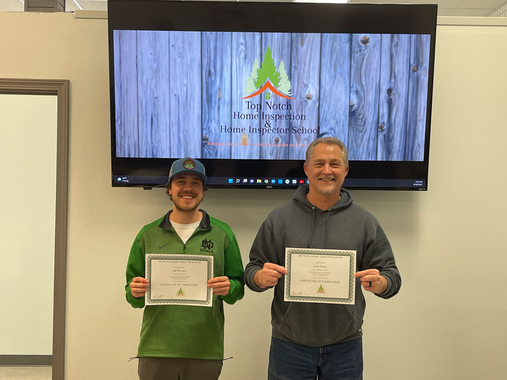 2 employees earning their home inspection certificate